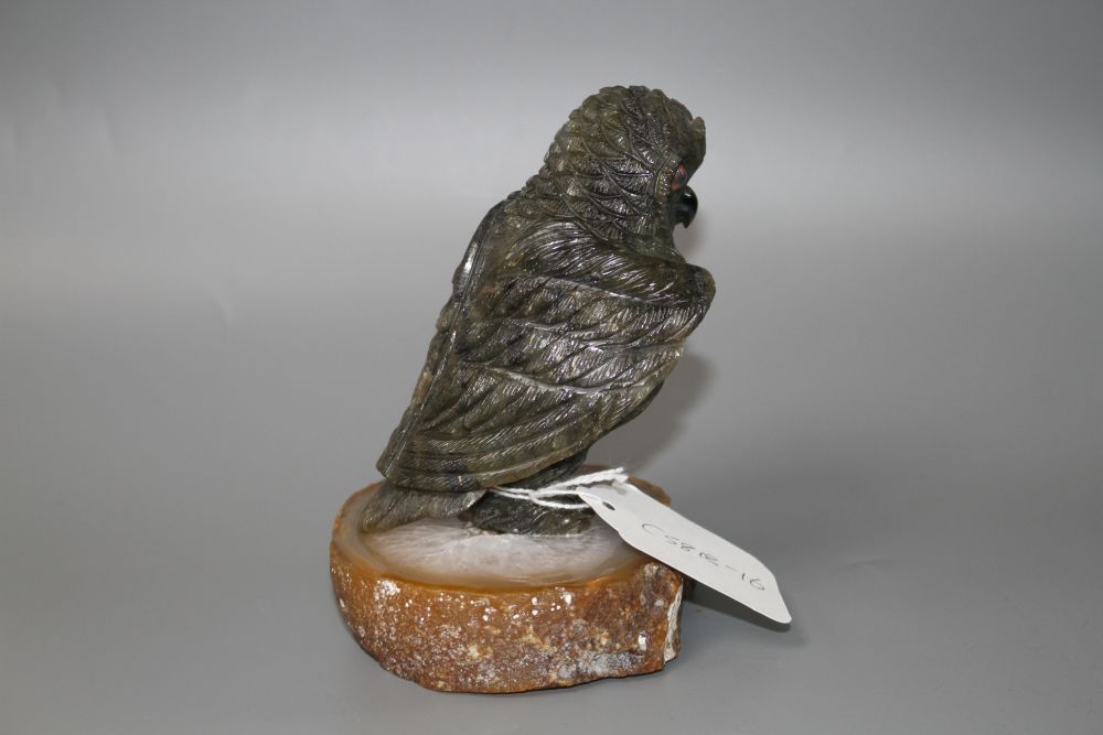 A carved labradorite model of an owl on an agate base, height 12.8cm.